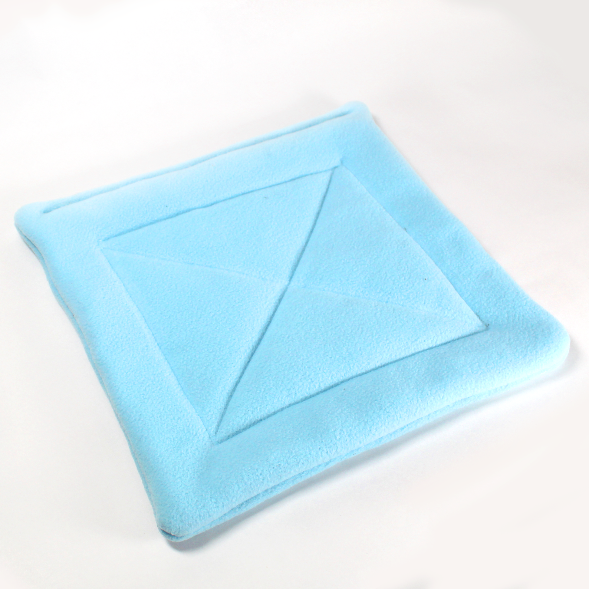 Large Square Light Blue Pee Pad for Guinea Pigs, close up front view with out a guinea pig of the pee pad showing the detail