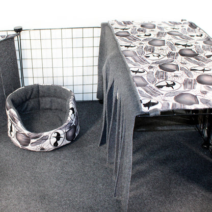 Cat bed with airplane pattern next to a table with a similar pattern in a room setting.
