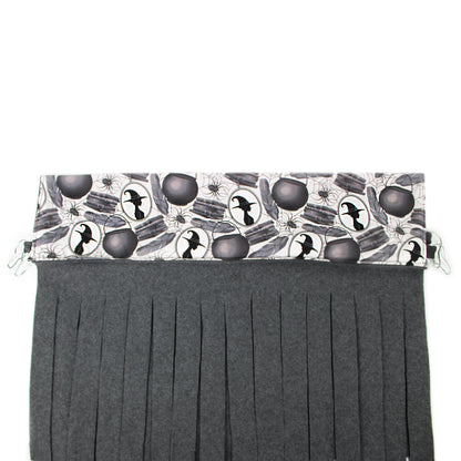 Black pleated skirt with Halloween-themed top section on a white background