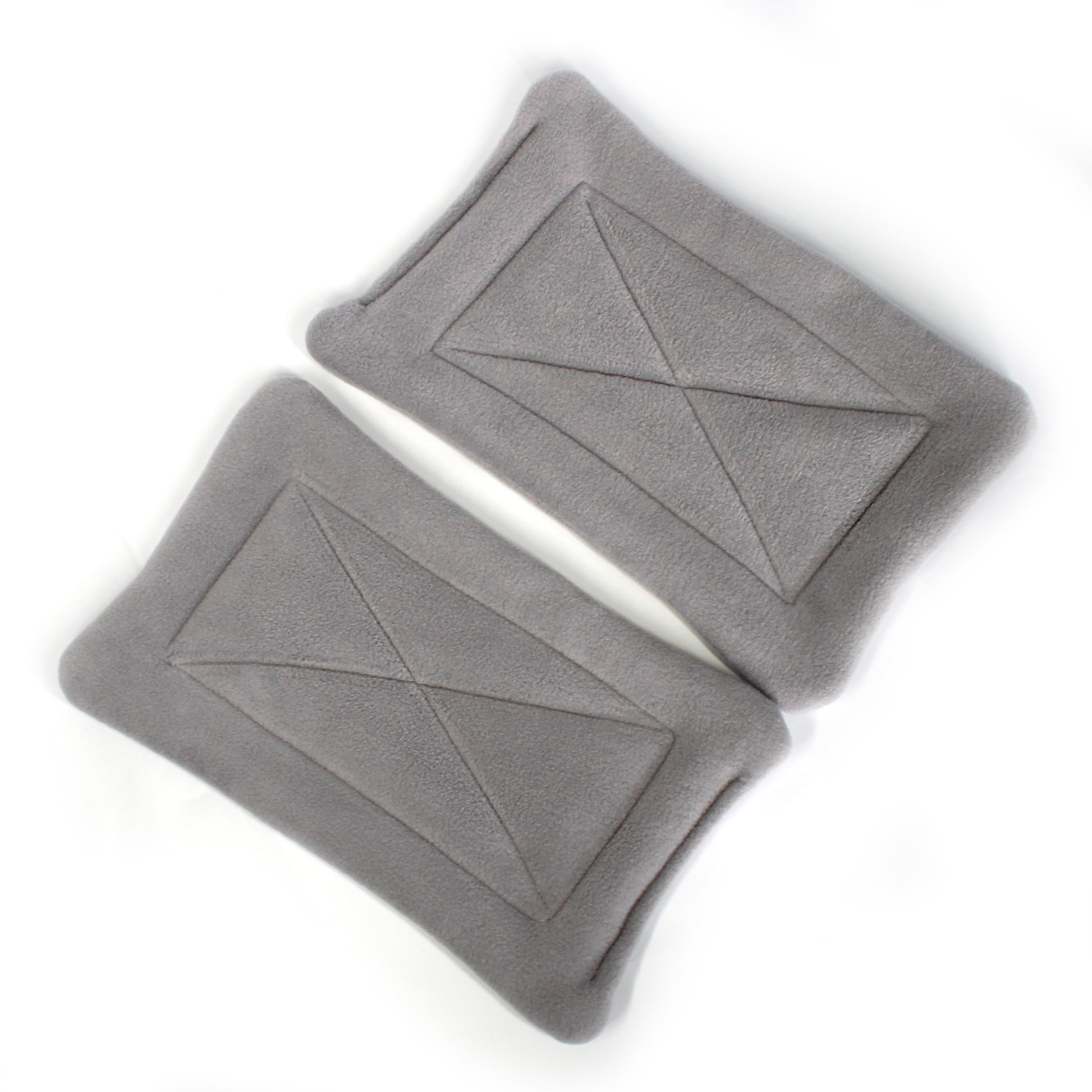 Two gray pee mats with geometric patterns on a white background