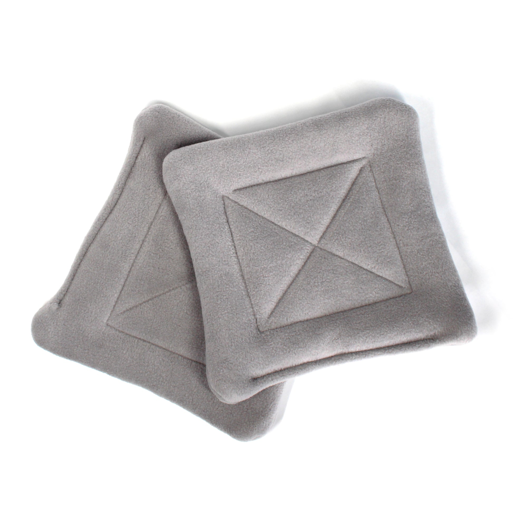 Gray textured pee pads with geometric patterns on a white background