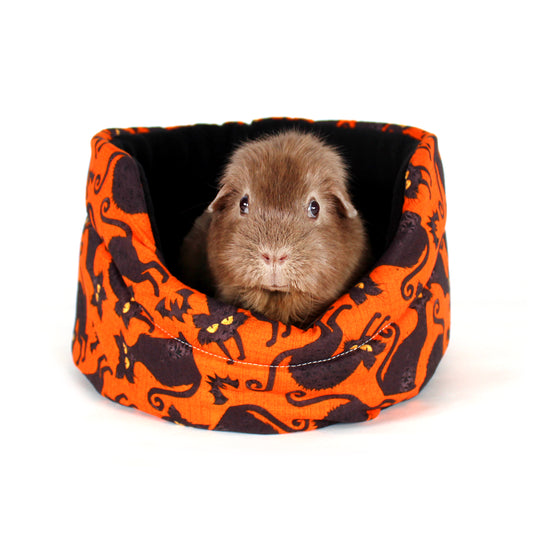 Halloween Black Cat Cuddle Cup Bed, front view of the bed for guinea pigs with a happy guinea pig inside