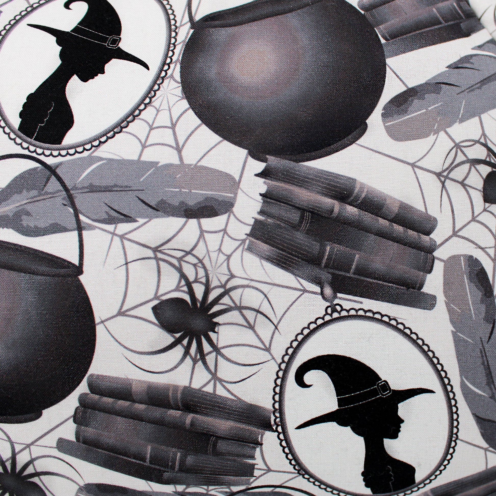 Halloween-themed design with cauldrons, books, and witch hats on a spider web background.
