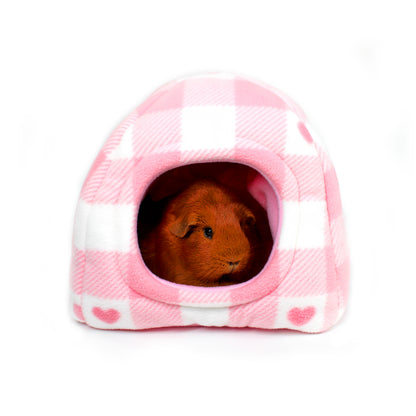 Small animal, likely a guinea pig, peeking out from a pink checkered pet house on a white background