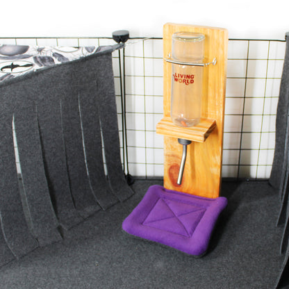 Wooden water bottle stand with a purple drip pad on a tiled wall background