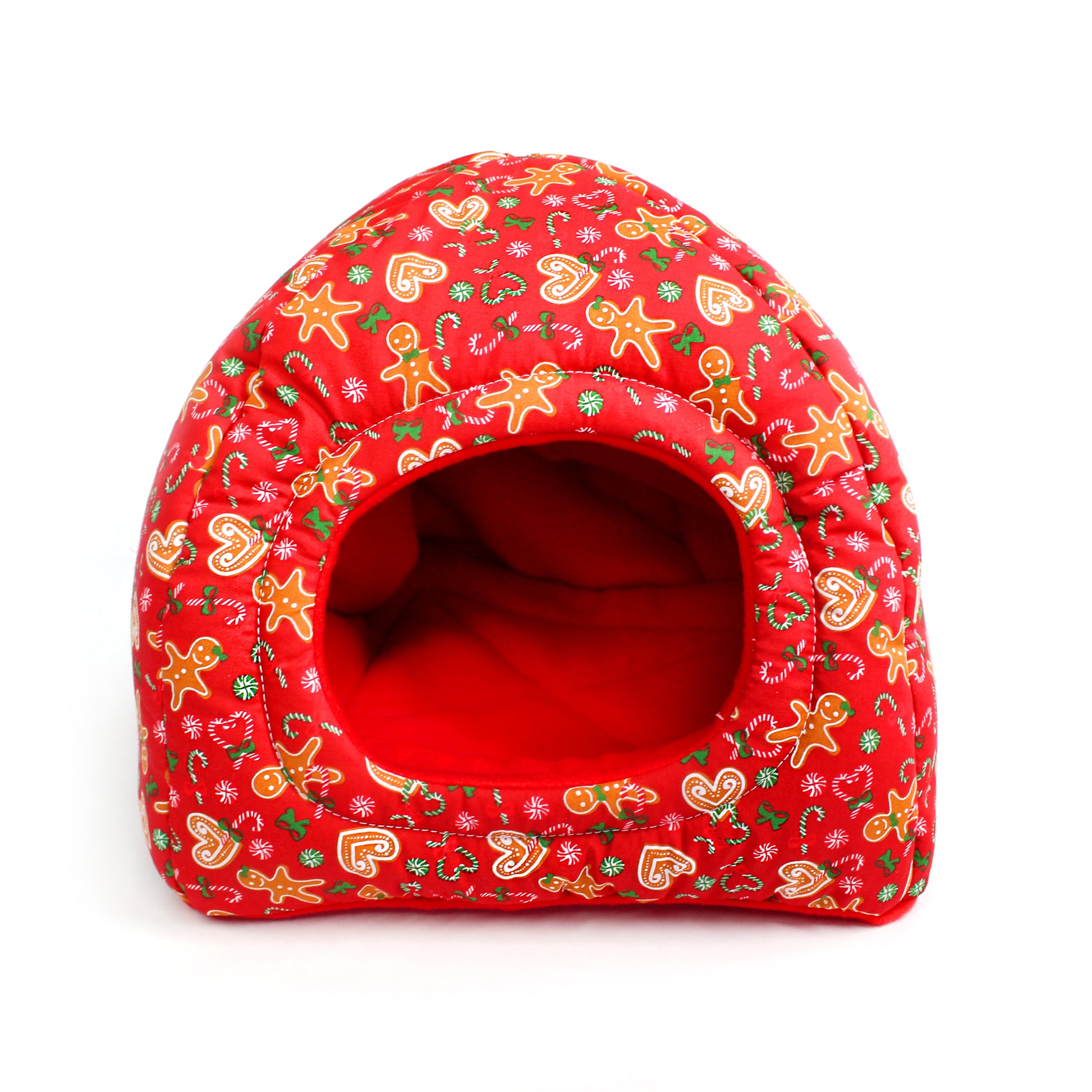 Red pet bed with gingerbread man pattern on a white background