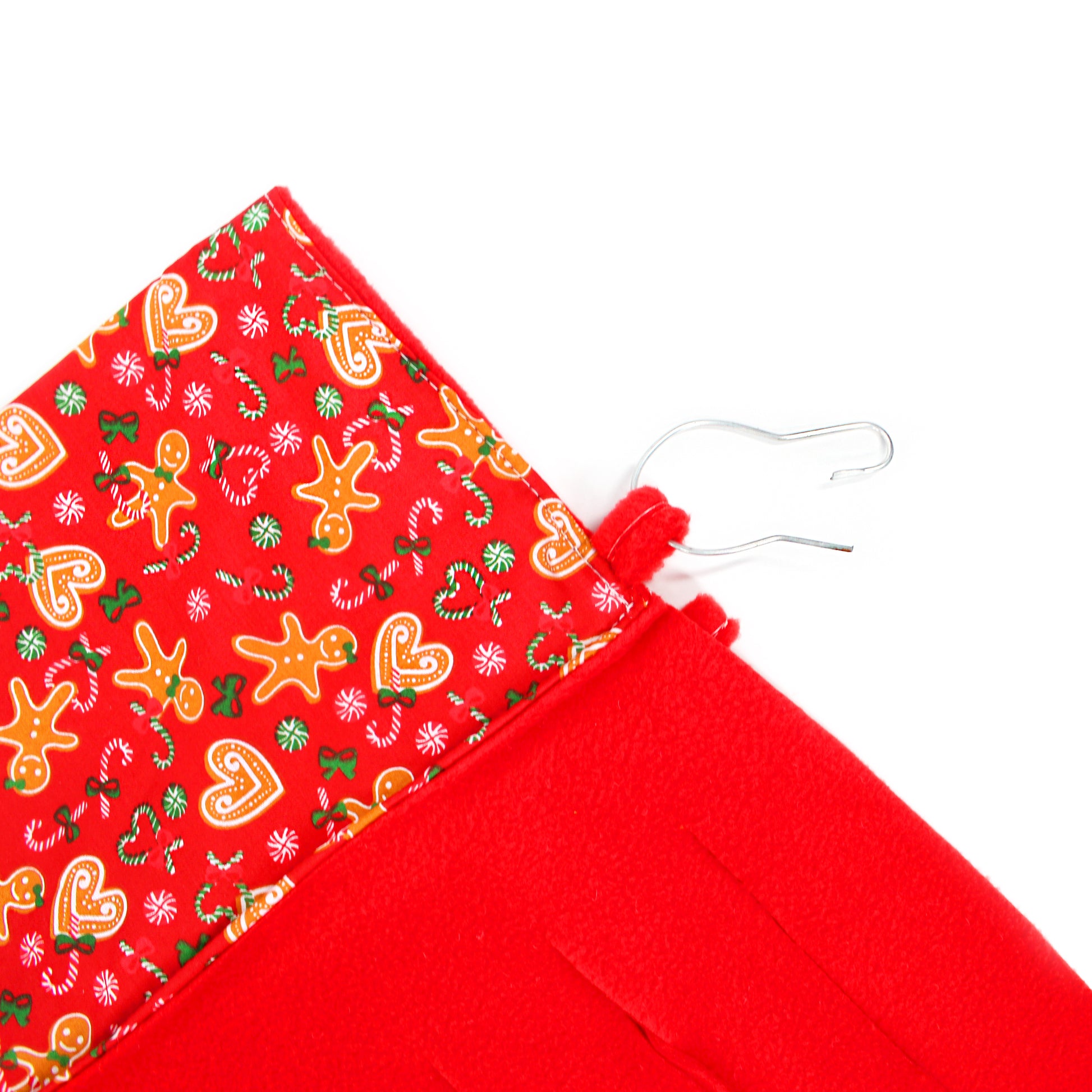 Red fabric with Christmas-themed pattern on a white background