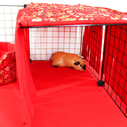 guinea pig hiding under a red fleece forest
