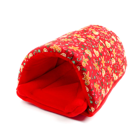 Red pet bed with gingerbread man pattern on a white background