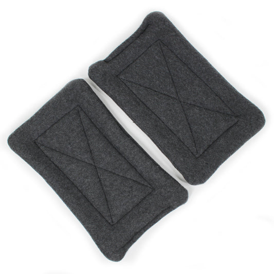Two gray fleece pee pads with geometric design on a white background