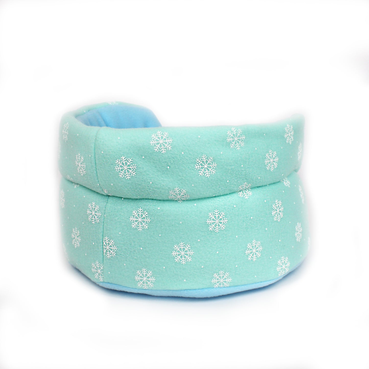 Turquoise pet bed with snowflake pattern on a white background