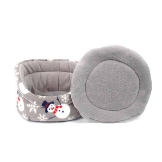 Gray pet bed with snowman design on a white background