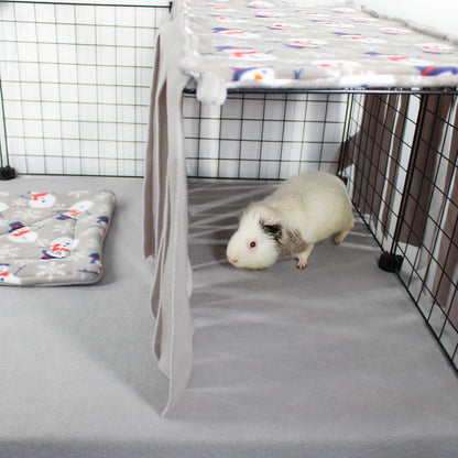 Guinea pig in a cage with a blanket and mat