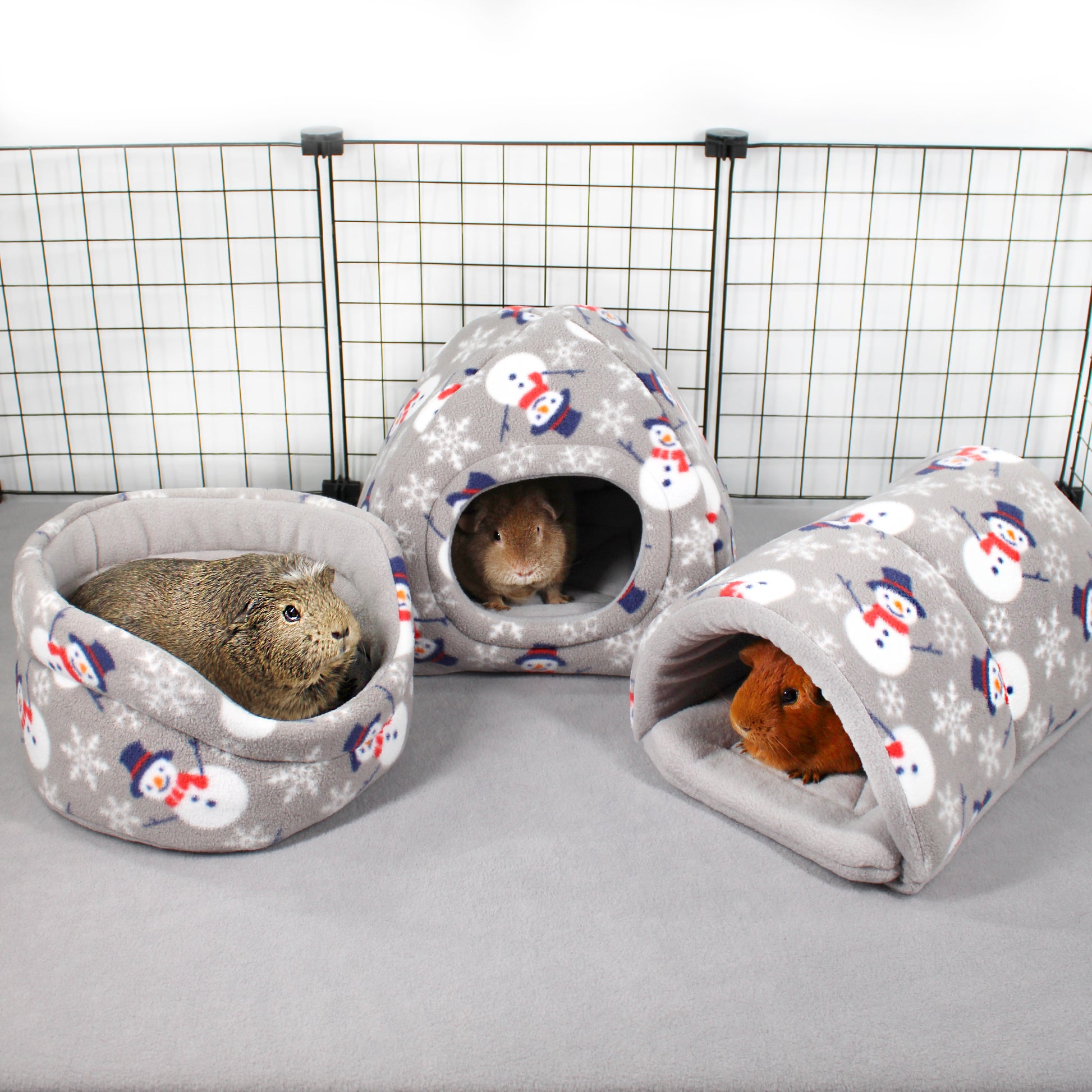 Three gray pet houses with snowman pattern on a white background