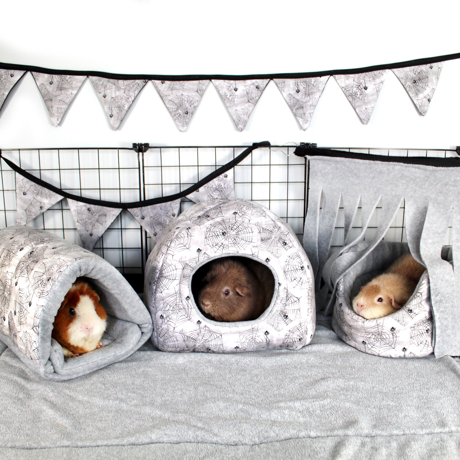 Halloween Spider Guinea Pig Accessory Bundle, Cuddle cup bed, Snuggle tunnel and hidey house in a full cage set up along with bunting and  a corner fleece forest to make a halloween themed cage for guinea pigs