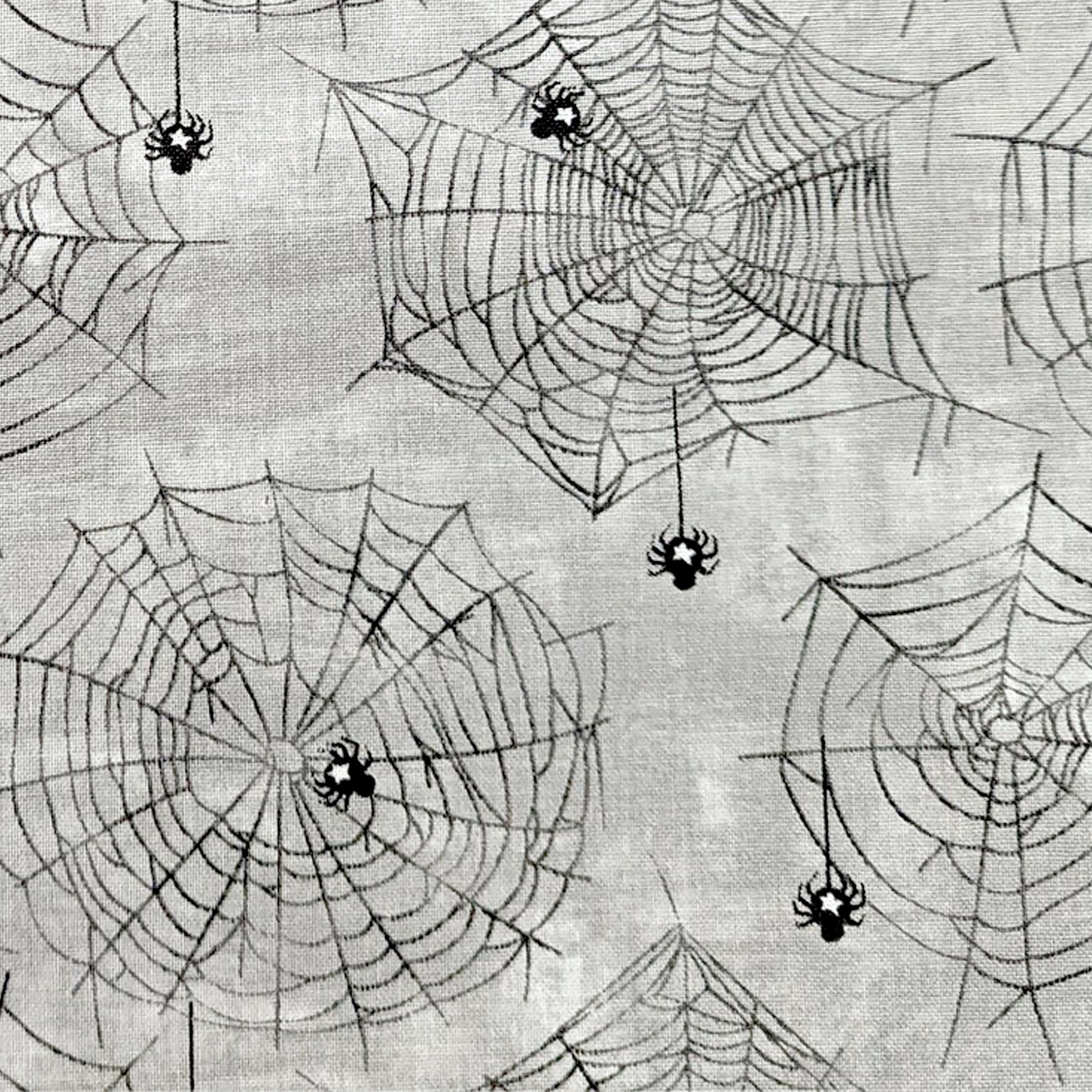 Halloween Spider Fabric, Close up of the cotton material showing the Subtle spider and web design on a grey background