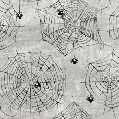 Halloween Spider Fabric, Close up of the cotton material showing the Subtle spider and web design on a grey background