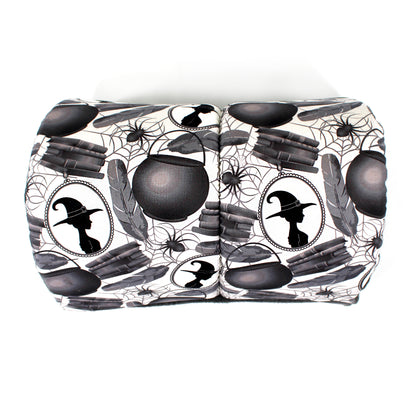 Halloween-themed guinea pig tunnel with black cauldrons, witch hats, and spider webs on a white background
