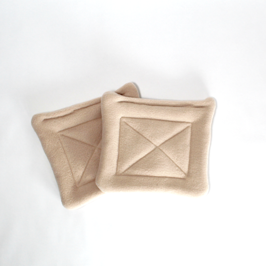 Pair Of Beige Water Bottle Drip Pads, the pair of drip pads shown from above
